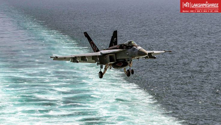 Military fighter jet flying low over the sea behind a naval vessel, illustrating rising military tensions in maritime hormuz conflict zones.